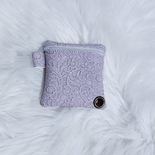 Purple lace pouch on a white fluffy surface