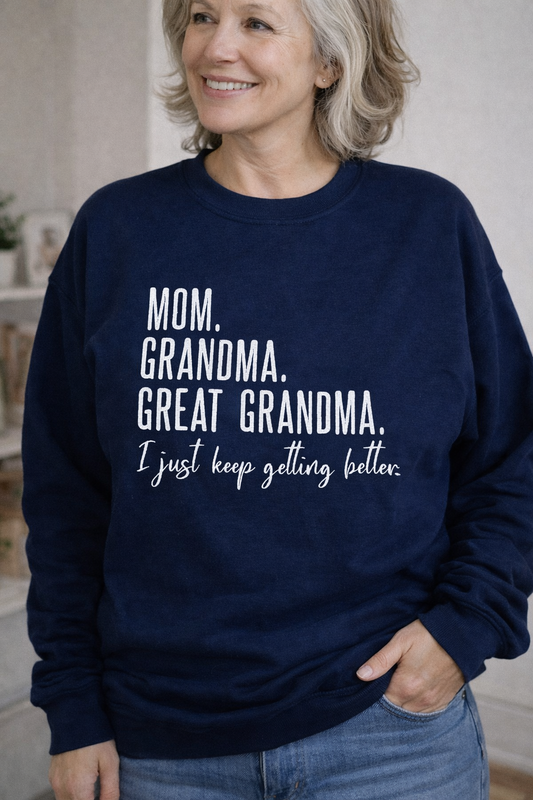 Woman wearing a navy sweatshirt with humorous text, standing indoors.